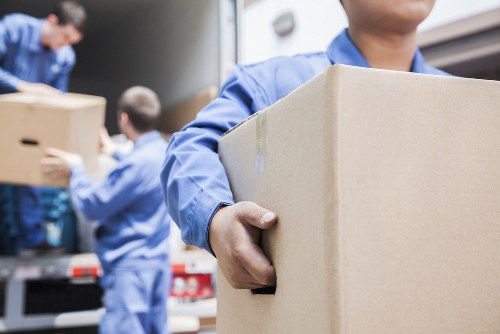Removal team loading boxes and furniture for a home move in Wales