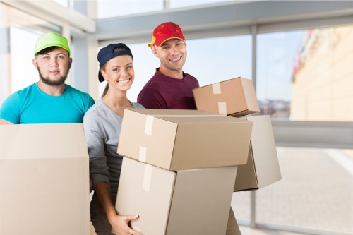Professional movers loading furniture into a van during a house removals job